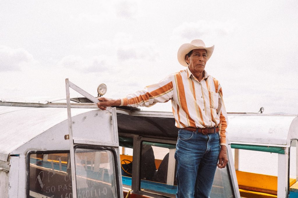 man in sombrero in boat door